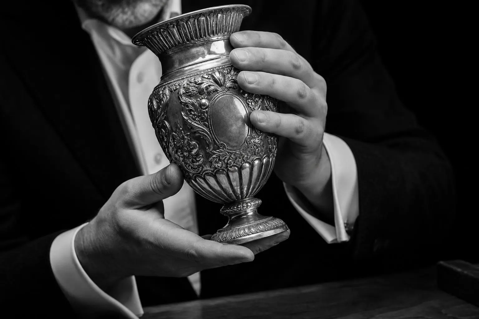 Appraiser examining a silver vessel